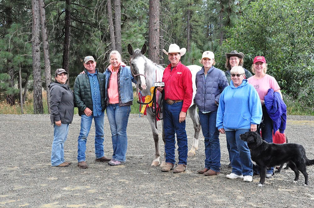 Matt Livengood and his mustang Mesa posing with their support crew at Mustang Madness 2019